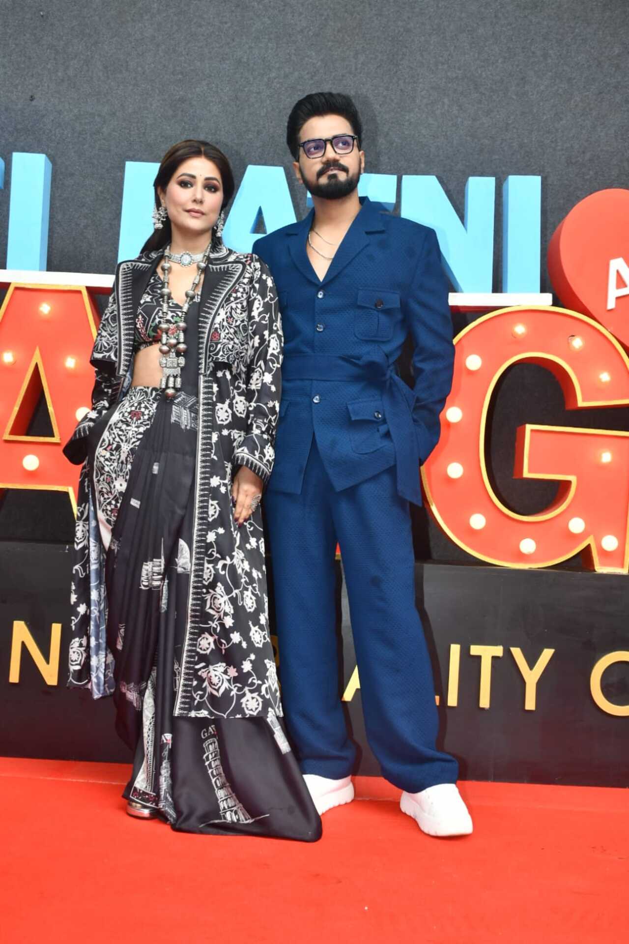 <p>Hina Khan was seen unleashing her fashionable side like always and looked gorgeous in a black saree with white print work. She paired it with long jacket of similar design. While Rocky complimented her in an all-blue attire.&nbsp;</p>